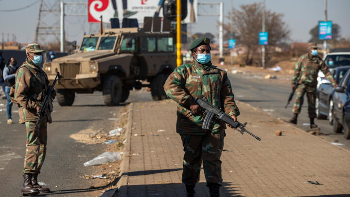 Soldiers patrol outside a shopping mall in Vosloorus, east of Johannesburg, South Africa, Wednesday, July 14, 2021.
